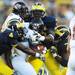 Michigan defense ties up UMass running back Jamal Wilson in the fourth quarter at Michigan Stadium on Saturday. Melanie Maxwell I AnnArbor.com